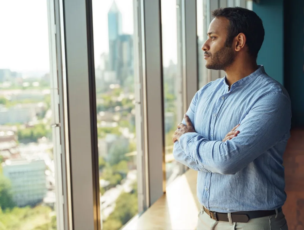 Operator looking out over the city from a high-rise office